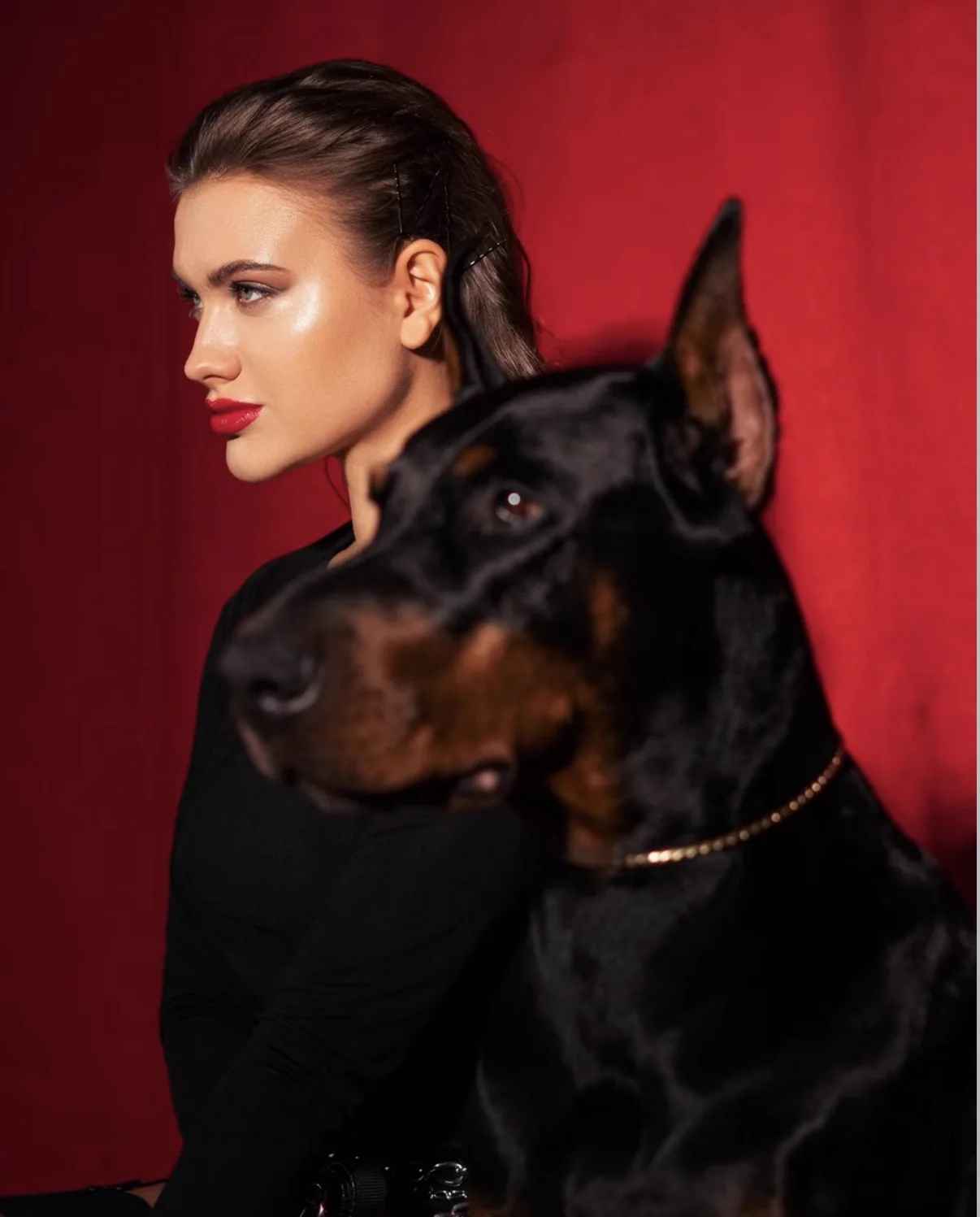 Red fashion editorial with a Doberman, photographed by Mariya Harley