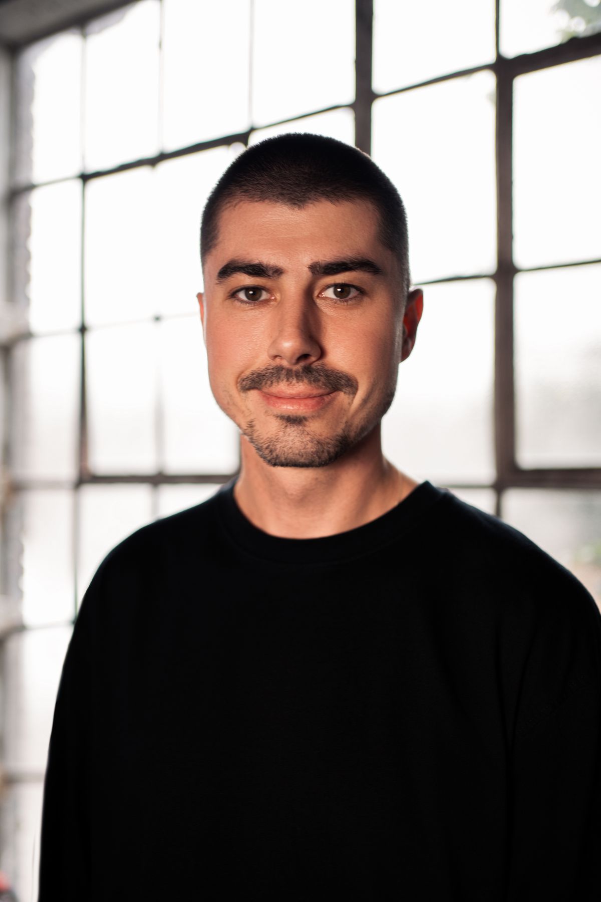 Professional headshot photographed in natural window light